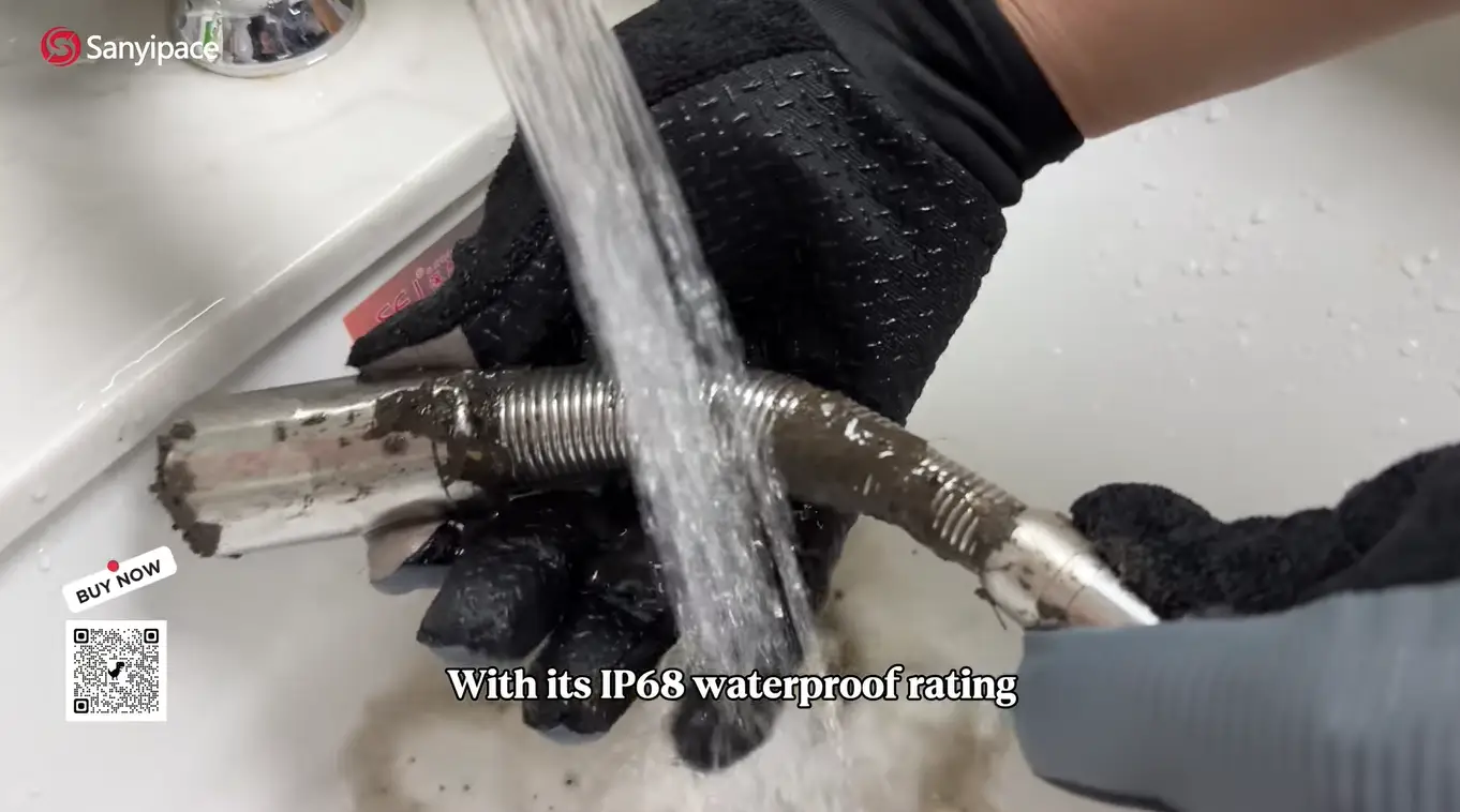person cleaning dirty metal pipe under running water in a sink wearing black gloves