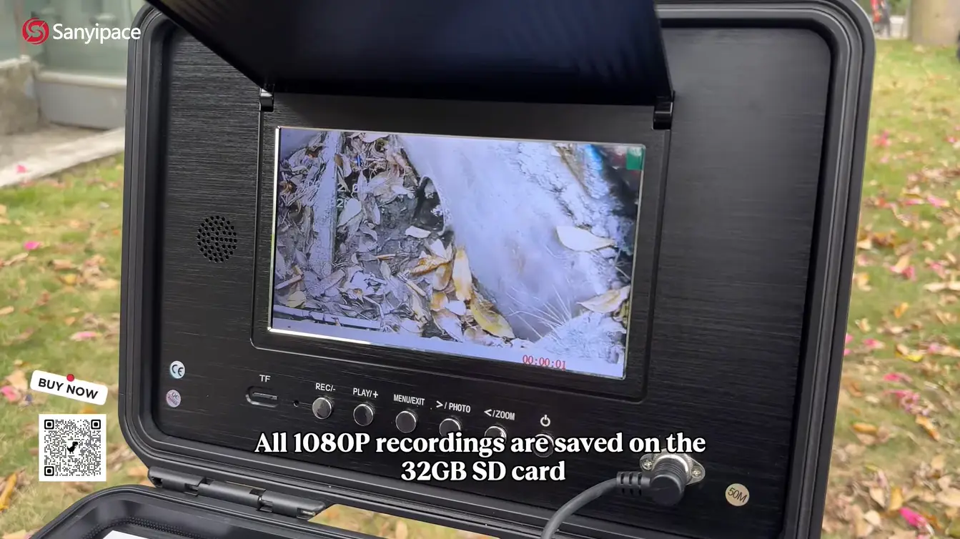 Outdoor view of portable inspection camera displaying an underground scene with fallen leaves