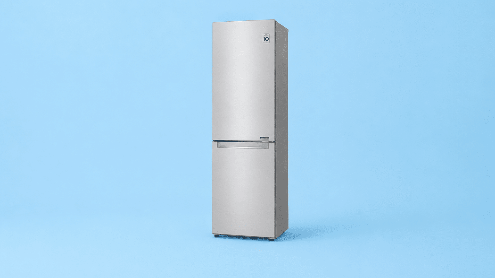 silver bottom freezer refrigerator standing against a light blue background in a clean studio setting with modern design and finish