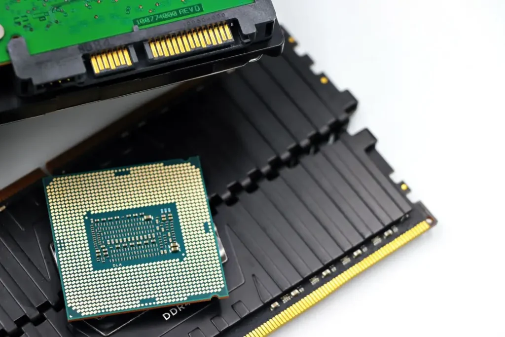 Close-up of computer processor and RAM modules on a white background