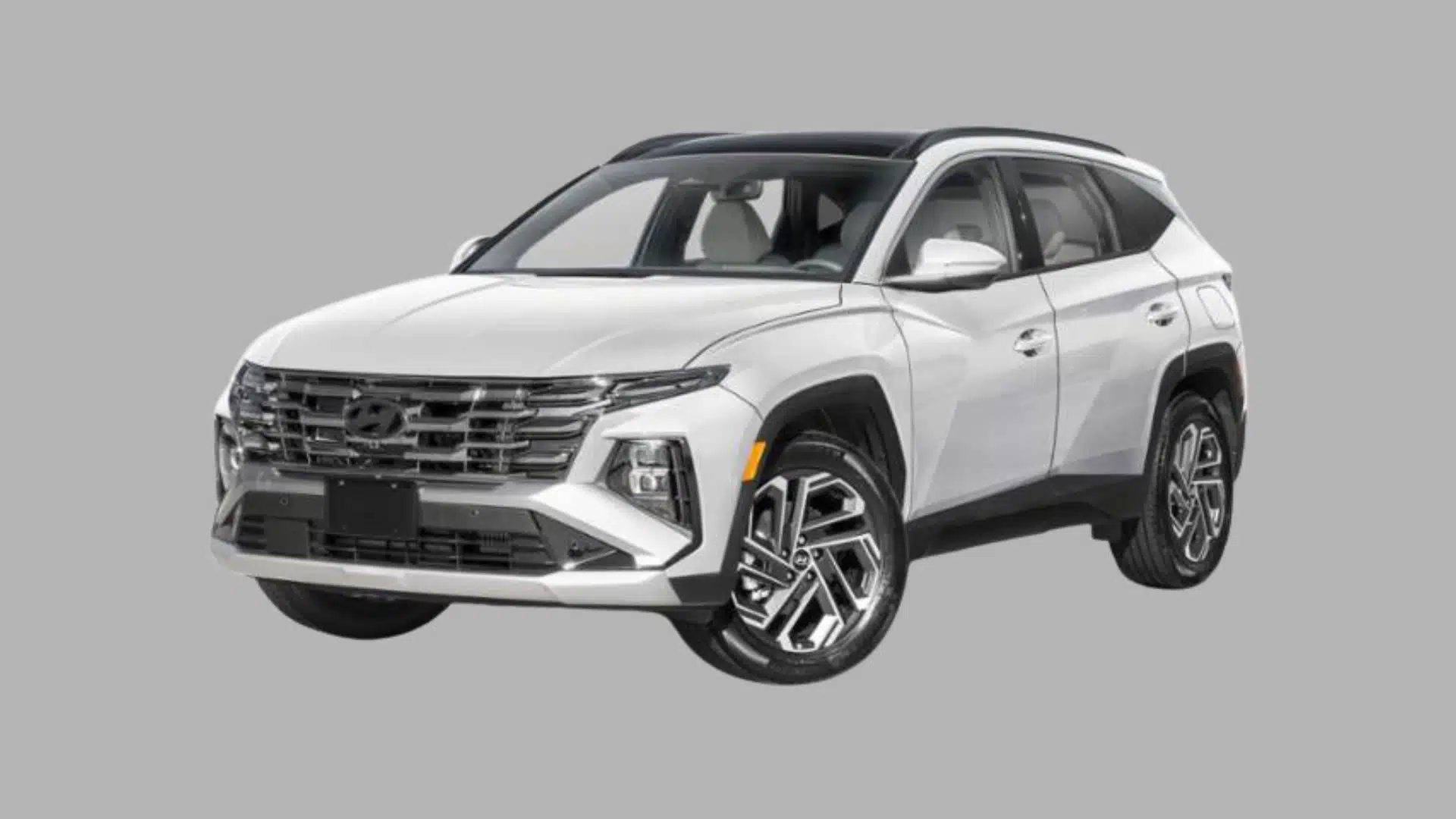 White Hyundai Tucson hybrid SUV with black roof accents and modern crossover styling on gray background