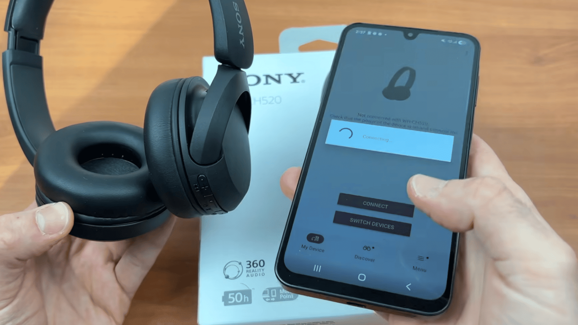 an android phone connecting to sony wh ch520 headphones while the headphones are held beside the retail box