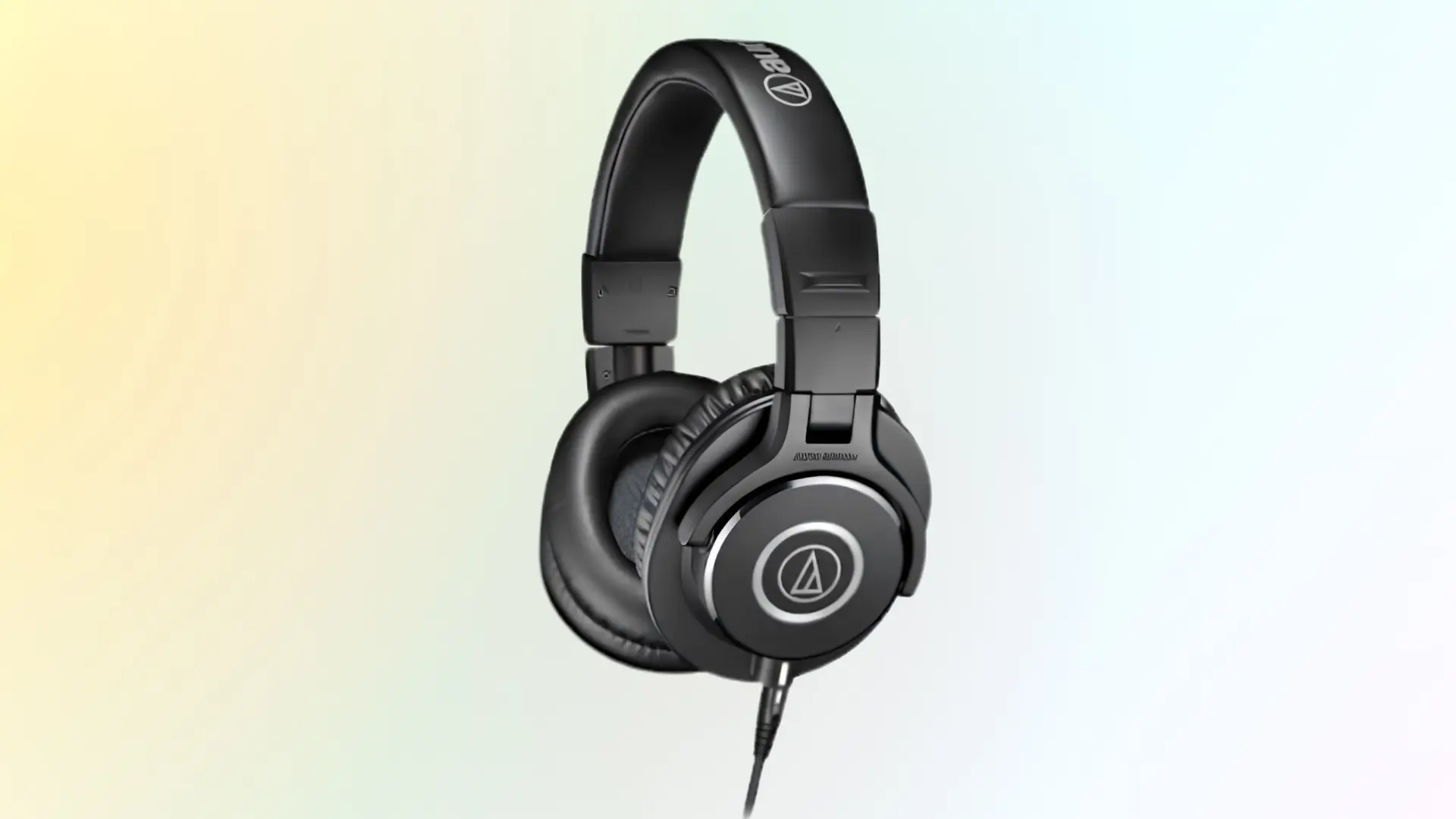 Audio-Technica ATH-M40x headphones with black closed-back earcups and wired design on a soft gradient background