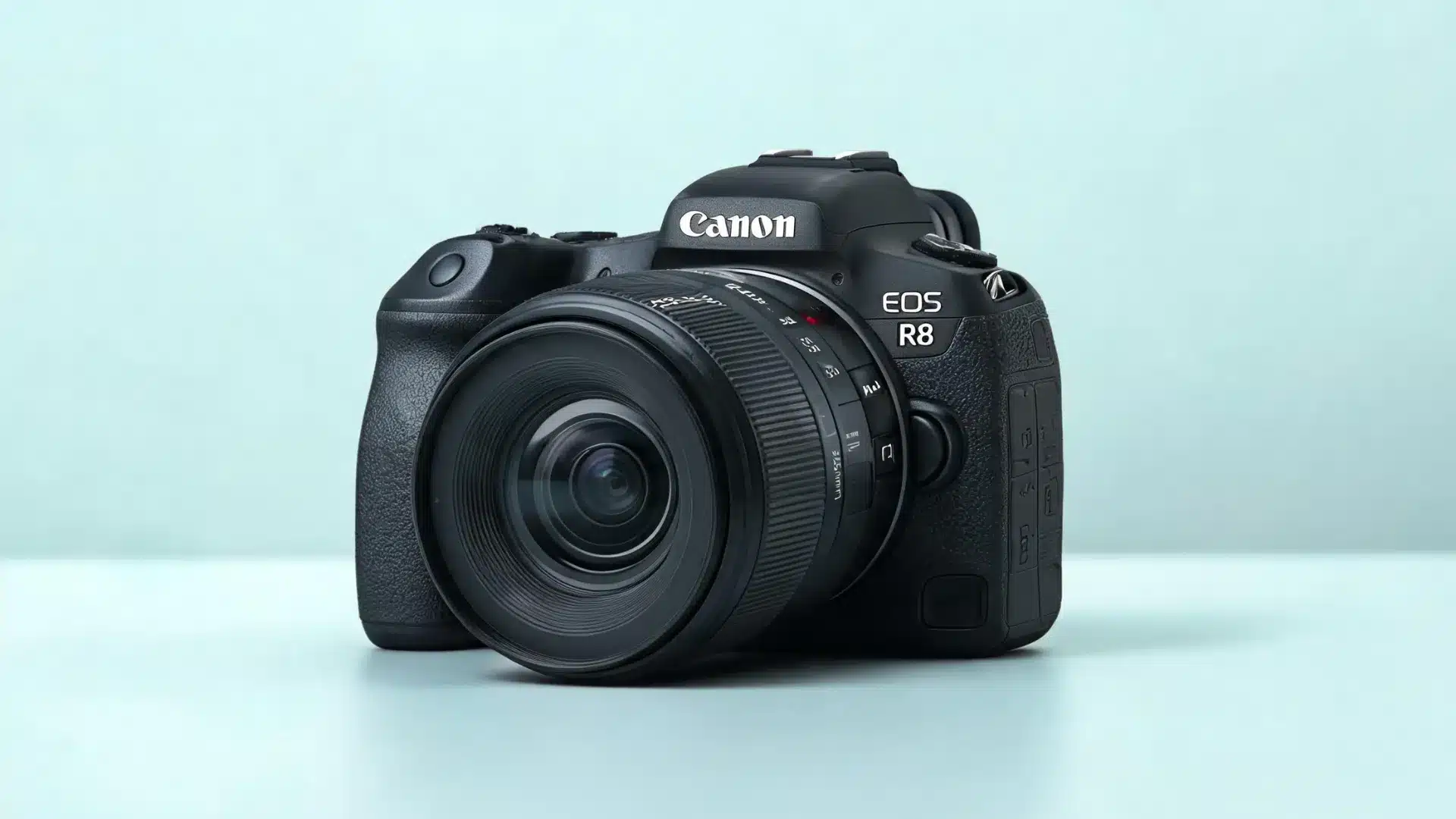 Canon EOS R8 mirrorless camera with RF 24-50mm lens on blue surface