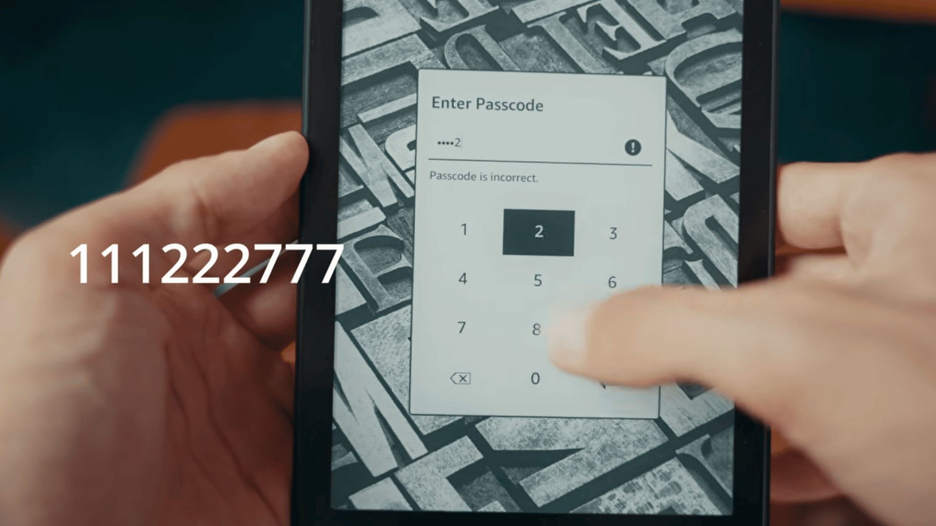 hands entering a passcode on a kindle ereader showing an incorrect passcode message on the lock screen (1)