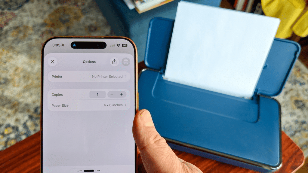 iPhone print settings screen displayed next to a wireless photo printer ready for AirPrint setup and photo printing