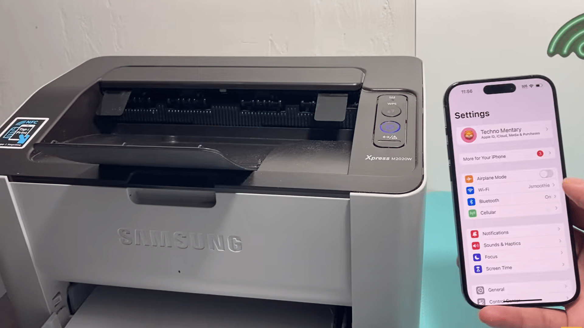 iphone settings screen displayed beside a wireless samsung printer showing setup for wireless printing connection