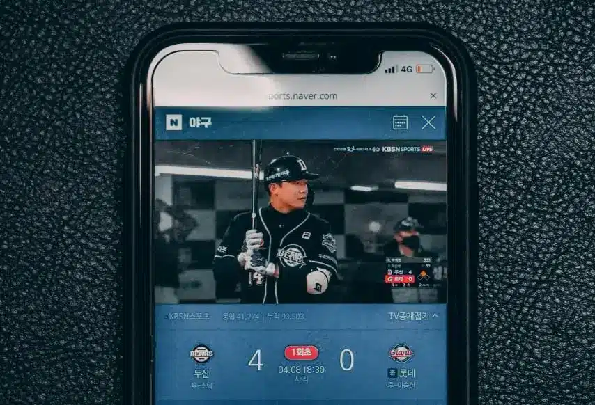 Smartphone displaying live baseball game with player holding bat on sports streaming app