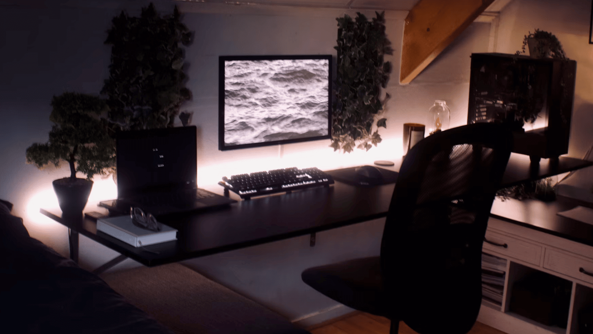 modern home office with dual computer setup ambient lighting indoor plants and organized workspace at night