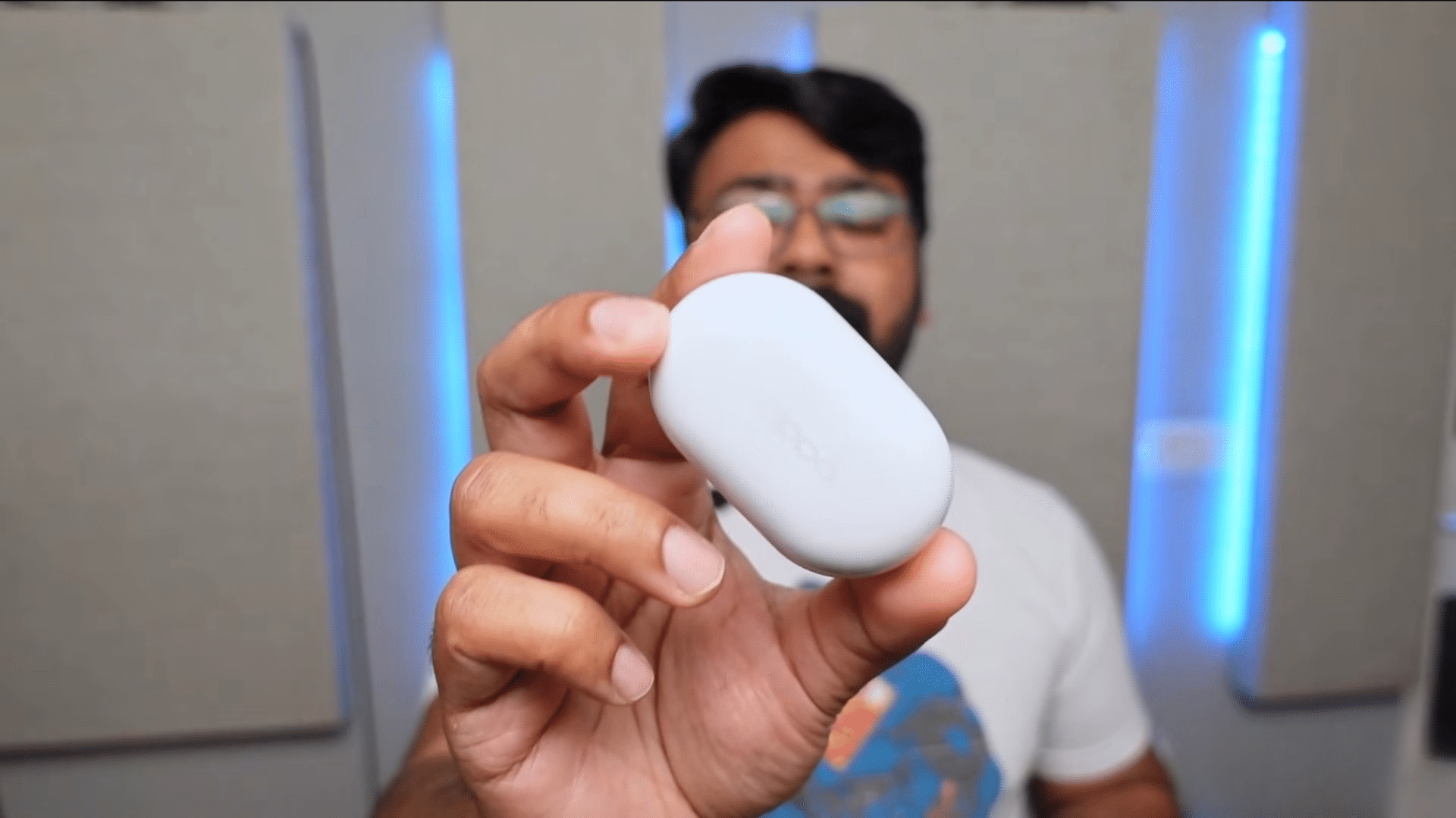 person turning off bluetooth headphones and disconnecting charging cable before starting the reset process
