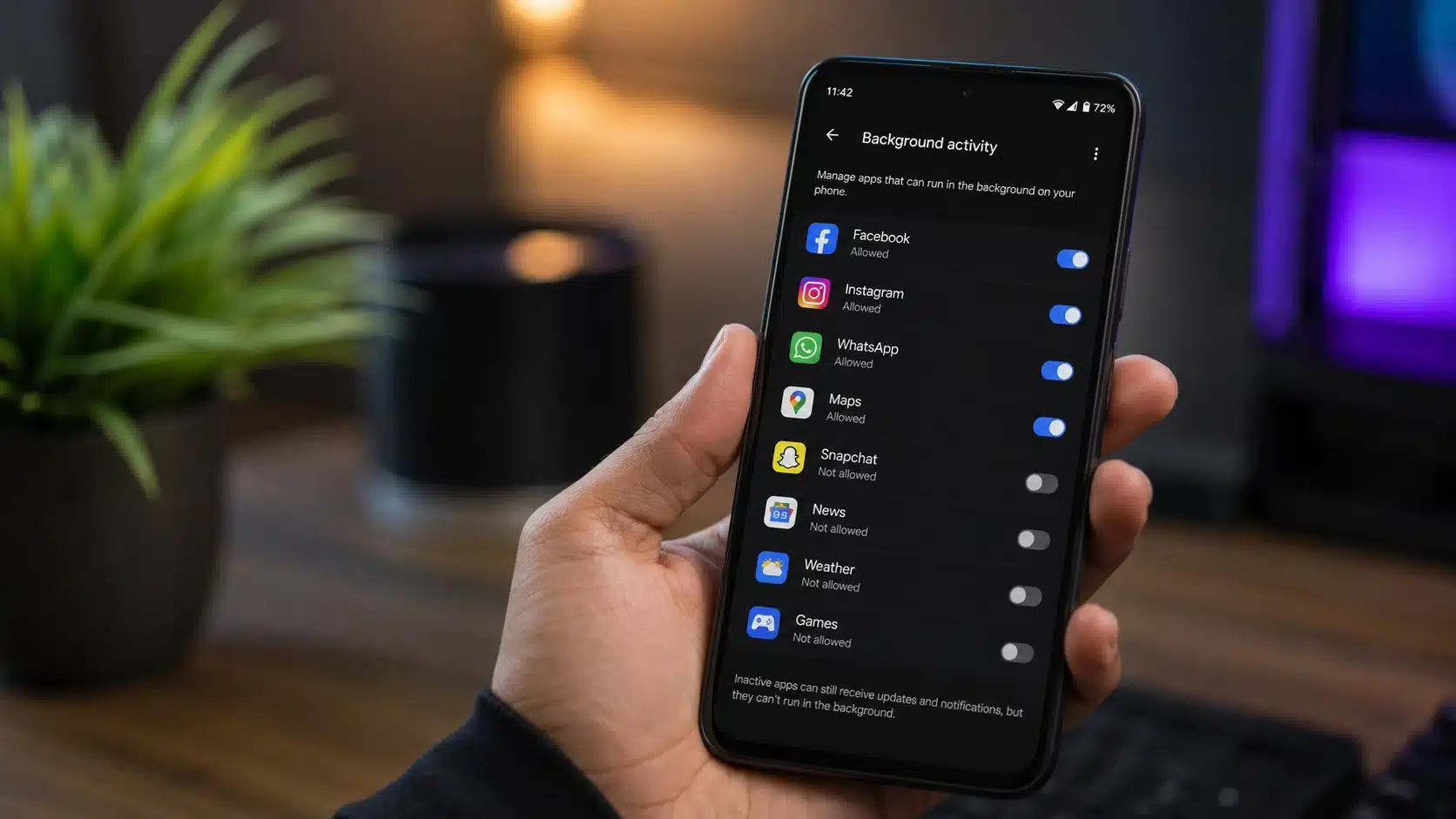 person viewing android background app management settings while enabling restrictions to reduce battery drain