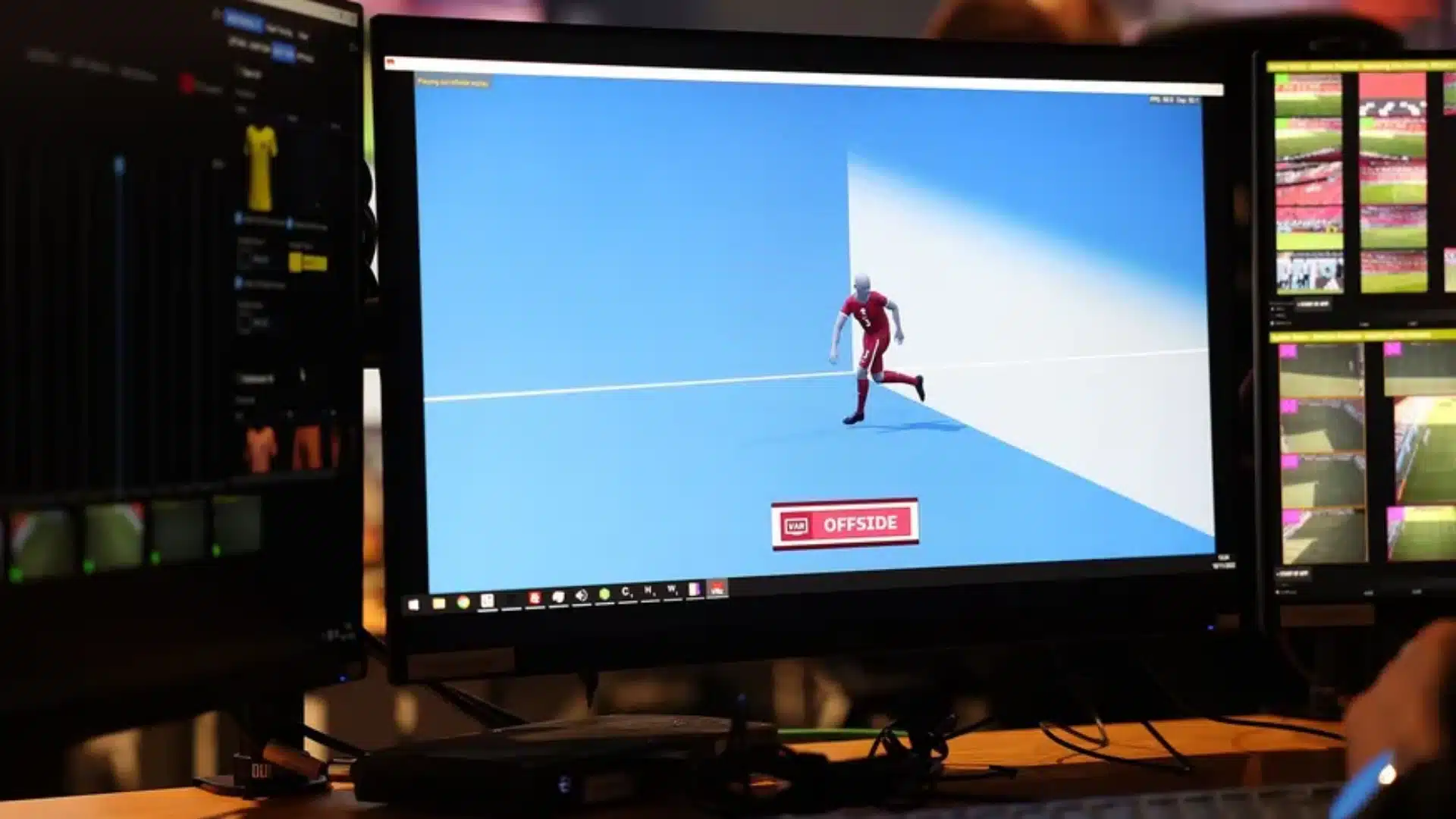 VAR offside review shown on a broadcast monitor in a football control room