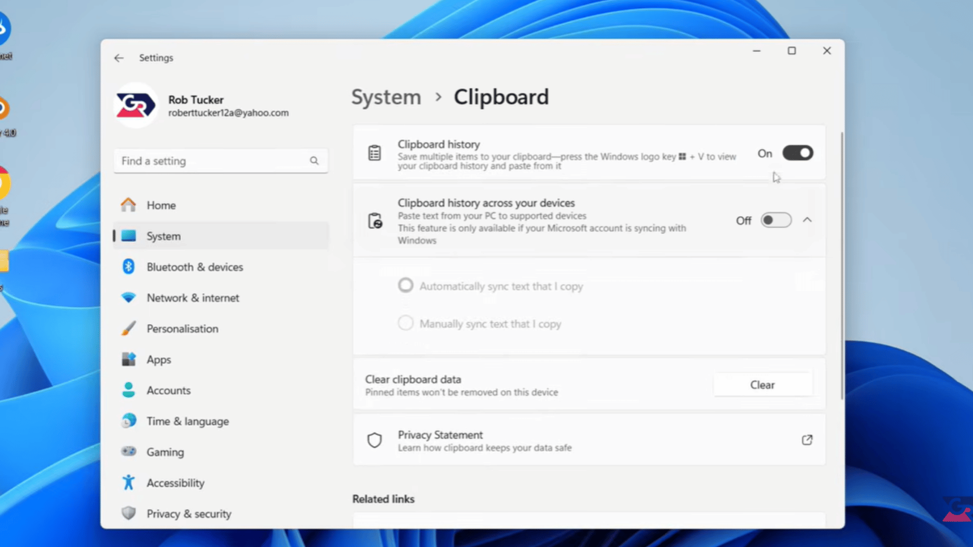 windows 11 clipboard history panel open showing a saved text entry beside the clipboard settings window