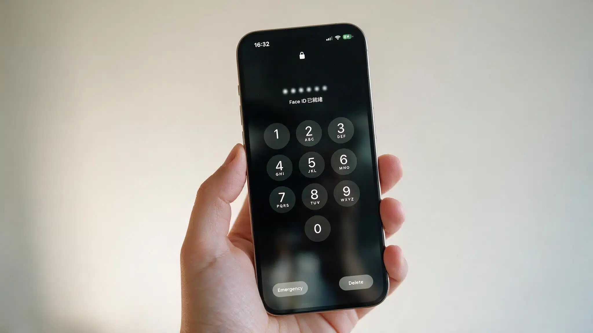a close up photo of an iphone showing the lock screen passcode keypad, held in one hand against a plain, softly lit background
