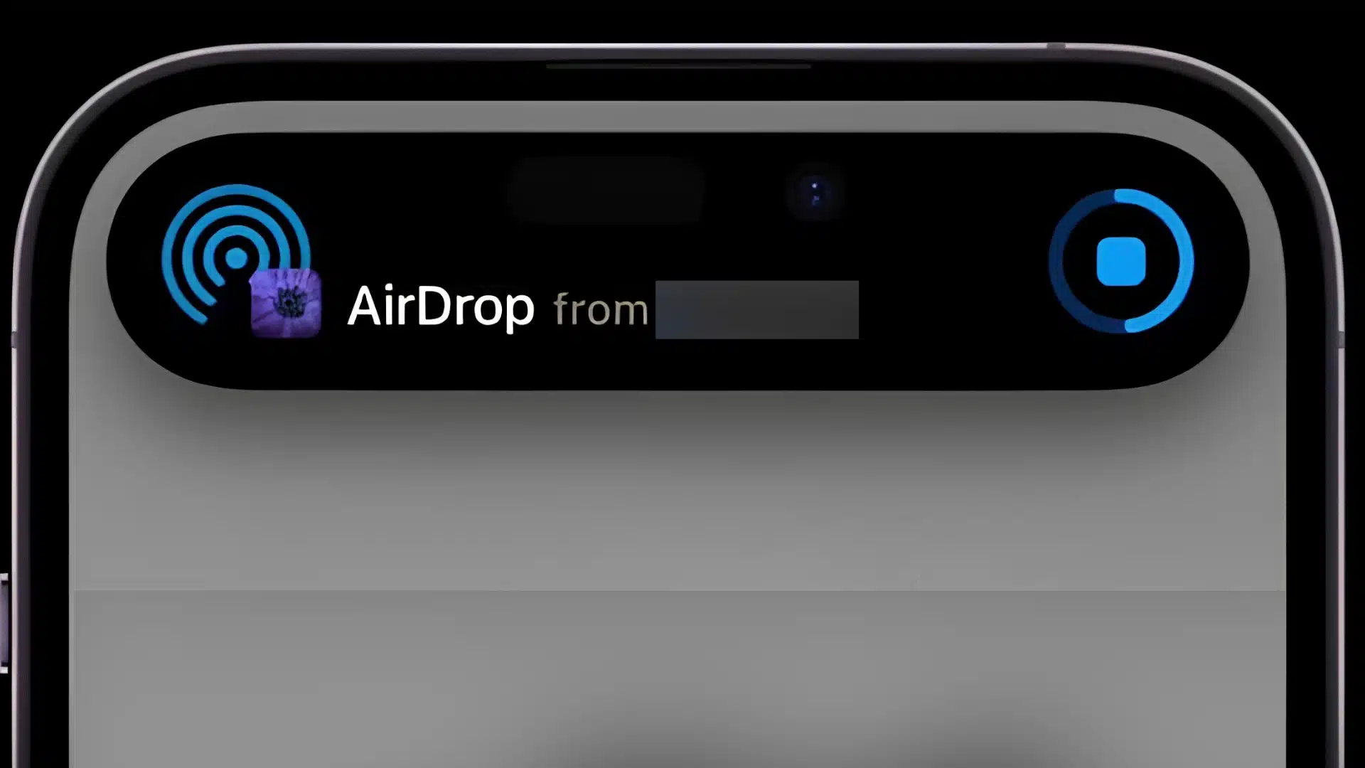 iphone dynamic island displaying an airdrop transfer notification across the top of the screen