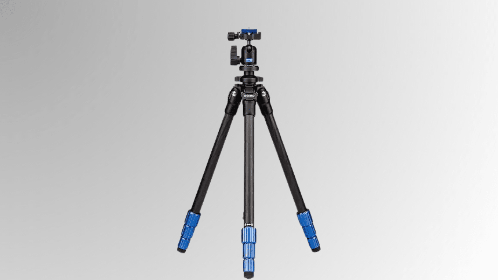 tall camera tripod with blue leg locks and mounted camera head on white background