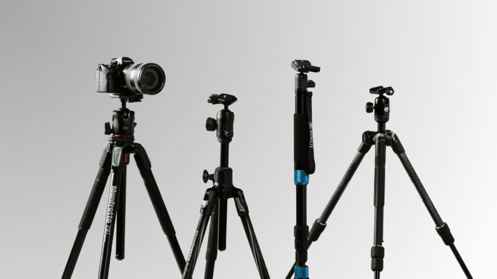 multiple black camera tripods with mounted cameras and adjustable legs displayed for budget photography setups