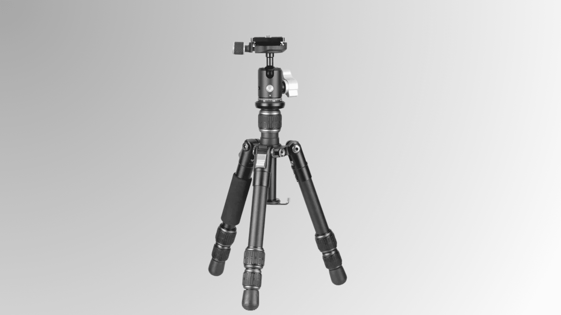 compact camera tripod with mounted device head and adjustable legs on white background